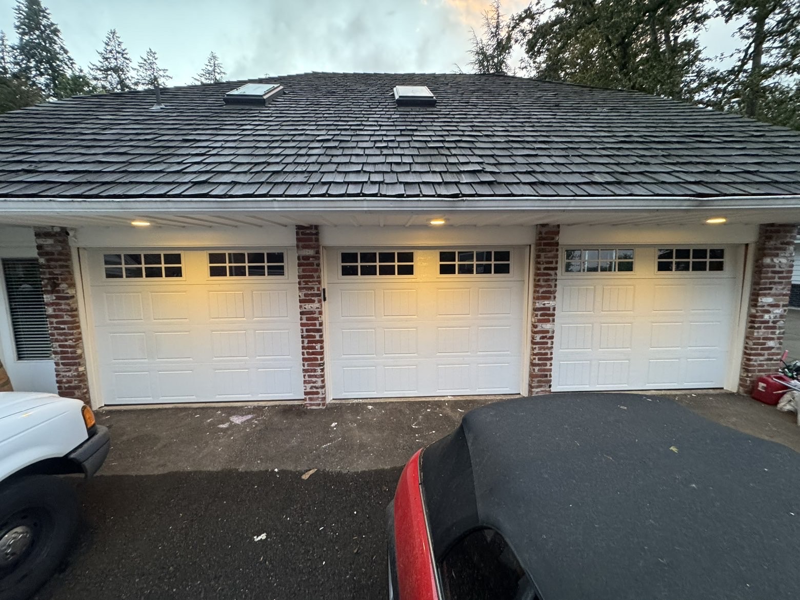 Modern black steel garage door on a cedar Pacific Northwest home